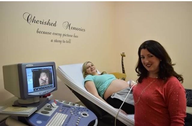 A lady doctor is performing ultrasound